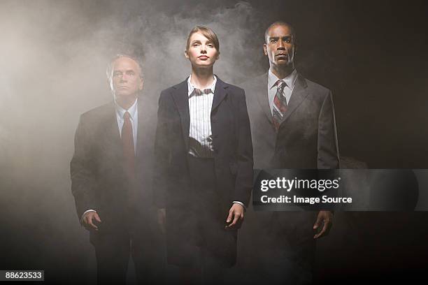 businesspeople in smoke - nebelmaschine stock-fotos und bilder