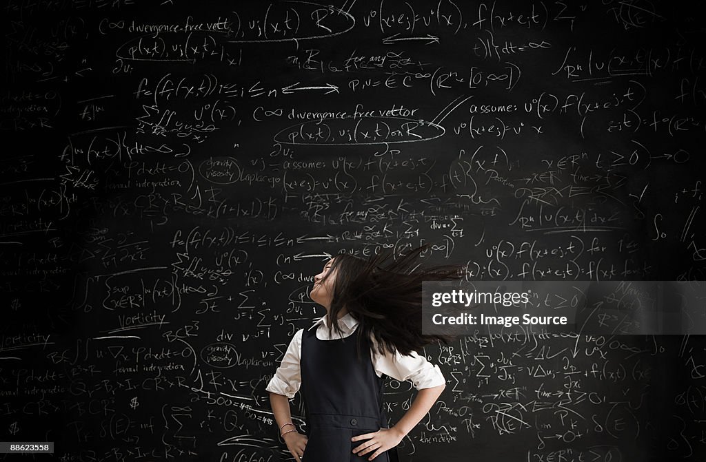 Girl moving in front of blackboard