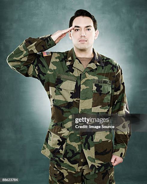 portrait of a soldier saluting - saluting stock pictures, royalty-free photos & images