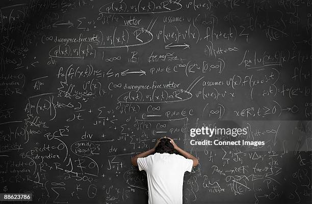 boy with formulae on blackboard - complex math equation stock pictures, royalty-free photos & images