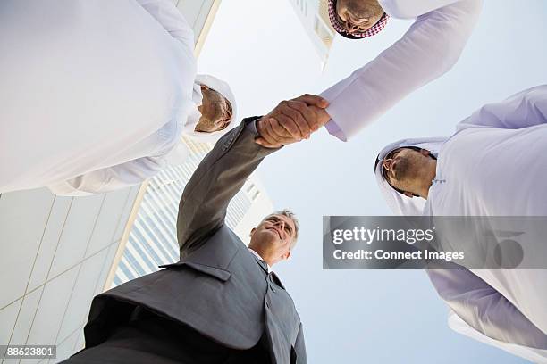 businessmen shaking hands - arab culture stock pictures, royalty-free photos & images
