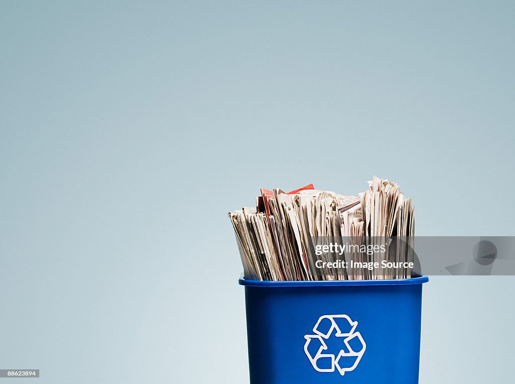 Newspapers in a recycling bin
