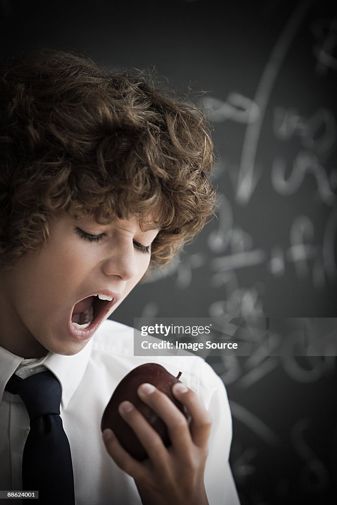 Boy eating an apple