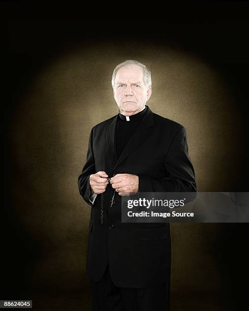 a priest holding prayer beads - priest collar stock pictures, royalty-free photos & images