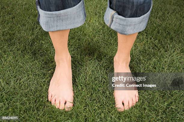 a woman standing on grass - standing barefoot stock pictures, royalty-free photos & images