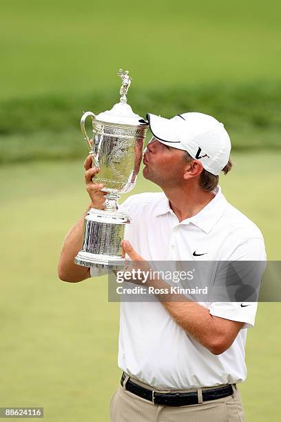 Lucas Glover kisses the winner's trophy after his two-stroke victory at the 109th U.S. Open on the Black Course at Bethpage State Park on June 22,...