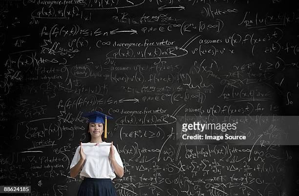 graduating girl in front of blackboard - high school maths stock pictures, royalty-free photos & images
