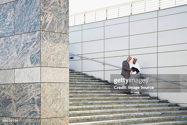 businessmen on steps - united arab emirates business stock pictures, royalty-free photos & images