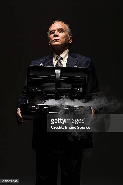 businessman with smoking briefcase - dry ice black background stock pictures, royalty-free photos & images