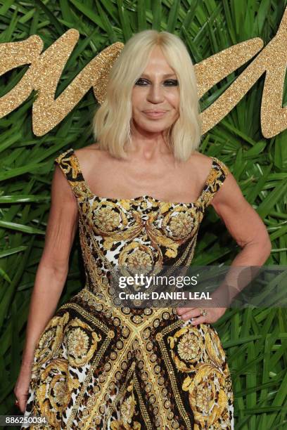 Italian designer Donatella Versace, who won the fashion icon award, poses on the red carpet upon arrival to attend the British Fashion Awards 2017 in...