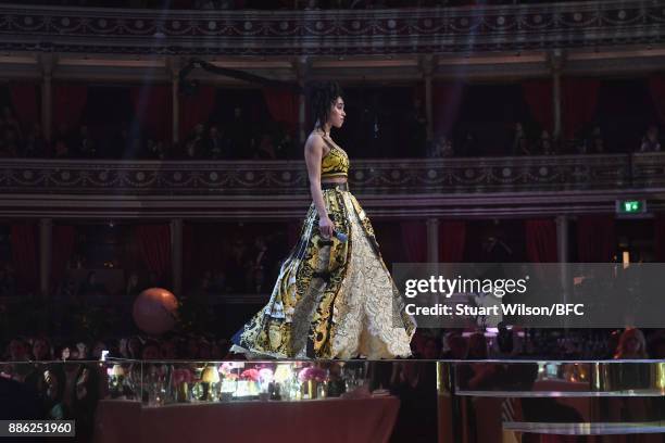 Twigs presents the British Designer of the Year Menswear award on stage during The Fashion Awards 2017 in partnership with Swarovski at Royal Albert...