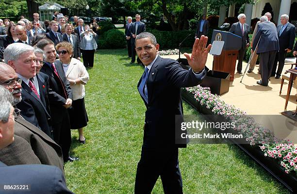 President Barack Obama waves to guests after signing the Family Smoking Prevention and Tobacco Control Act during a ceremony in the Rose Garden at...