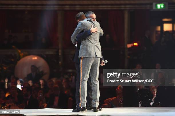 Raf Simons winner of the Designer of the Year award and Oliver Sim on stage during The Fashion Awards 2017 in partnership with Swarovski at Royal...