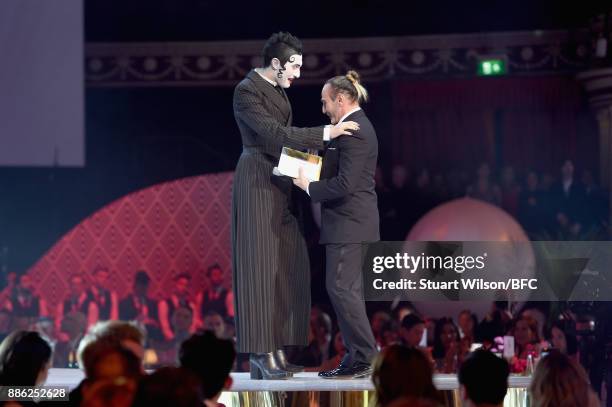 Charles Jeffrey , winner of the British Emerging Talent Menswear award, and John Galliano on stage during The Fashion Awards 2017 in partnership with...