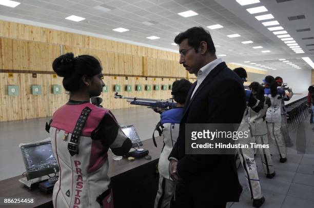 Union Minister of State for Youth Affairs and Sports Rajyavardhan Singh Rathore having a word with shooters at the new 10M range of Madhya Pradesh...