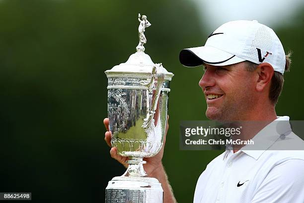 Lucas Glover celebrates with the winner's trophy after his two-stroke victory at the 109th U.S. Open on the Black Course at Bethpage State Park on...