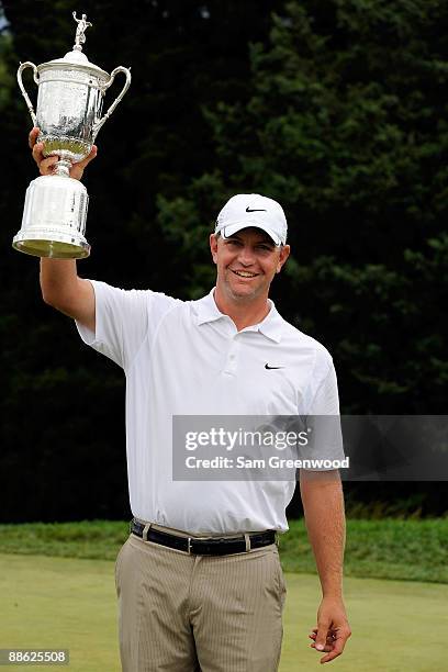 Lucas Glover celebrates with the winner's trophy after his two-stroke victory at the 109th U.S. Open on the Black Course at Bethpage State Park on...