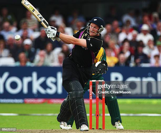 Andrew Gale of Yorkshire Carnegie on his way to a half century as Chris Read of Notts Outlaws looks on during the Twenty20 Cup match between...