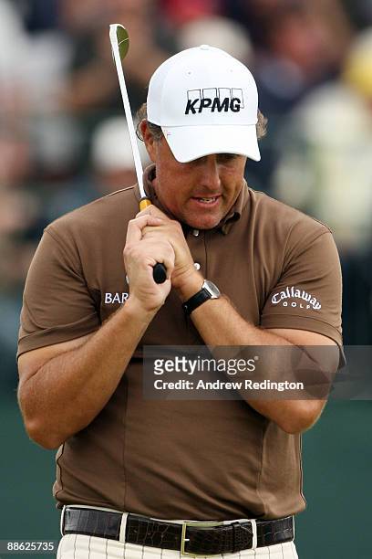 Phil Mickelson reacts to a missed putt on the 18th green during the continuation of the final round of the 109th U.S. Open on the Black Course at...