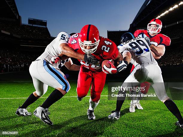 football running back running through defendersh - tackling ストックフォトと画像