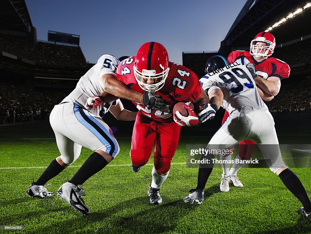 Football running back running through defendersh