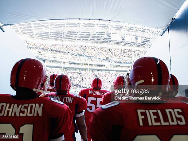 football team preparing to enter crowded stadium - american football player stock pictures, royalty-free photos & images