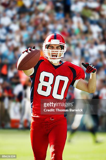 football receiver celebrating in crowded stadium - touchdown letters stock pictures, royalty-free photos & images