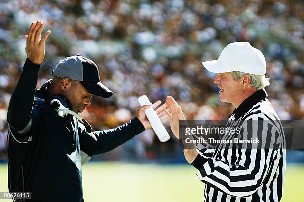 football coach and referee having disagreement - coaching formacion stock-fotos und bilder