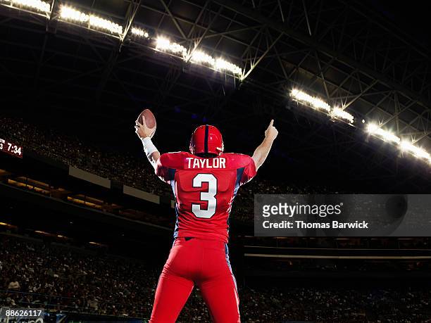 professional football player celebrating arms up - touchdown stock pictures, royalty-free photos & images