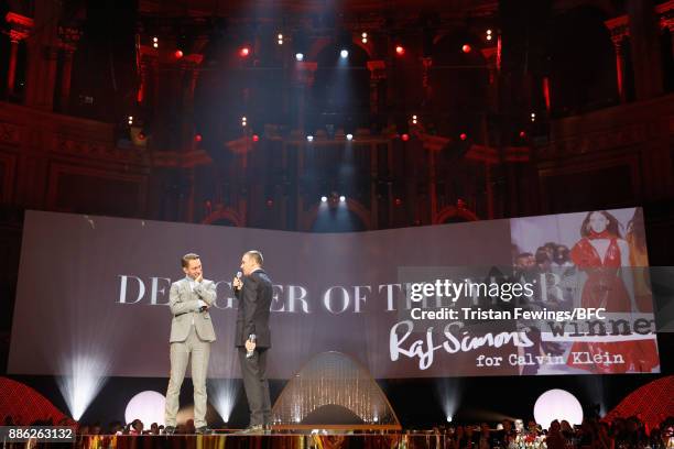 Raf Simons winner of the Designer of the Year award and Oliver Sim on stage during The Fashion Awards 2017 in partnership with Swarovski at Royal...