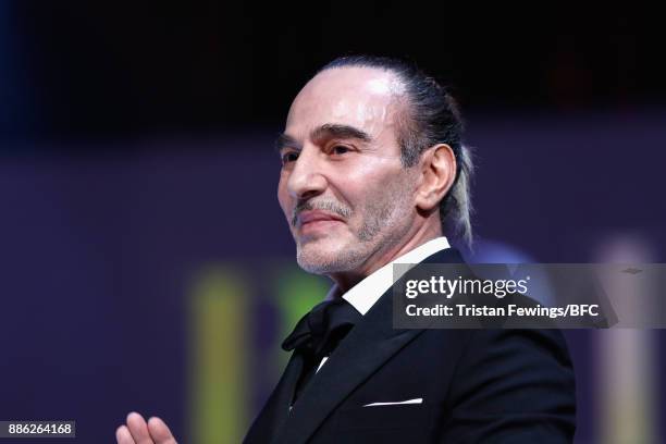John Galliano presents the British Emerging Talent Menswear award on stage during The Fashion Awards 2017 in partnership with Swarovski at Royal...