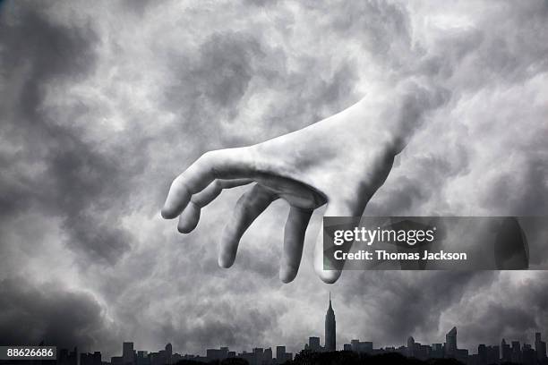 menacing hand looming over city - apokalypse stock-fotos und bilder