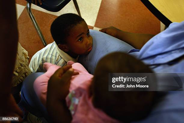 Jennifer Ross sits in a homeless shelter with her five children on June 18, 2009 in Dallas, Texas. Ross moved into the Family Gateway homeless...