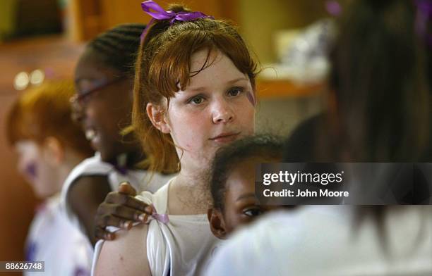 Ashley Potts stands with fellow homeless children while practicing a dance routine for a talent show on June 20, 2009 in Dallas, Texas. She was...