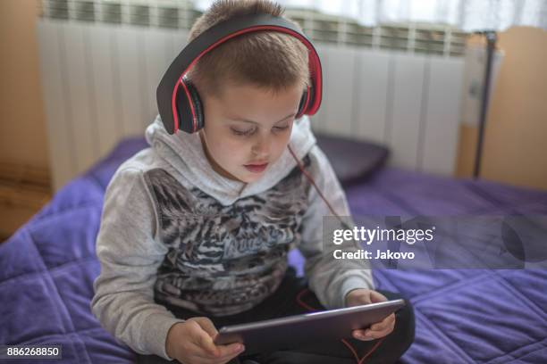 siblings - bonding - electronic listening device stock pictures, royalty-free photos & images