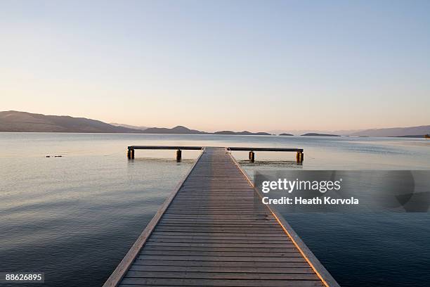 scenic view of a dock with sunset approaching. - lake foto e immagini stock