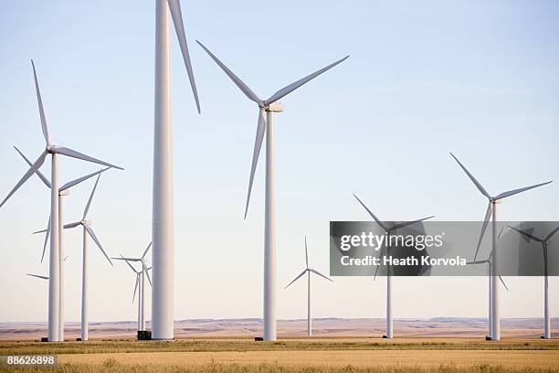 a large group of wind turbines in montana. - wind power stock-fotos und bilder