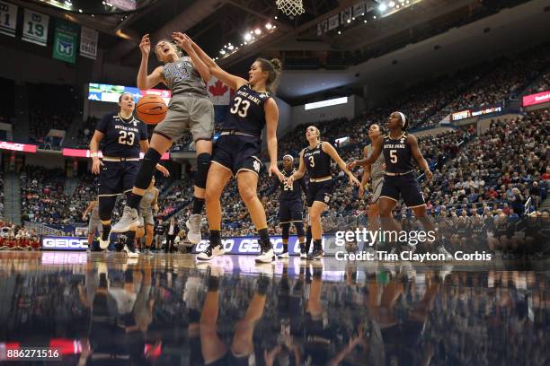 Katie Lou Samuelson of the Connecticut Huskies is challenged by Kathryn Westbeld of the Notre Dame Fighting Irish during the the UConn Huskies Vs...