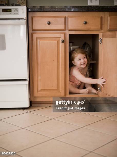 child hiding in cabinet - hide and seek stock pictures, royalty-free photos & images