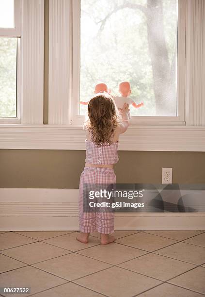 girl holding dolls - american girl doll stock pictures, royalty-free photos & images
