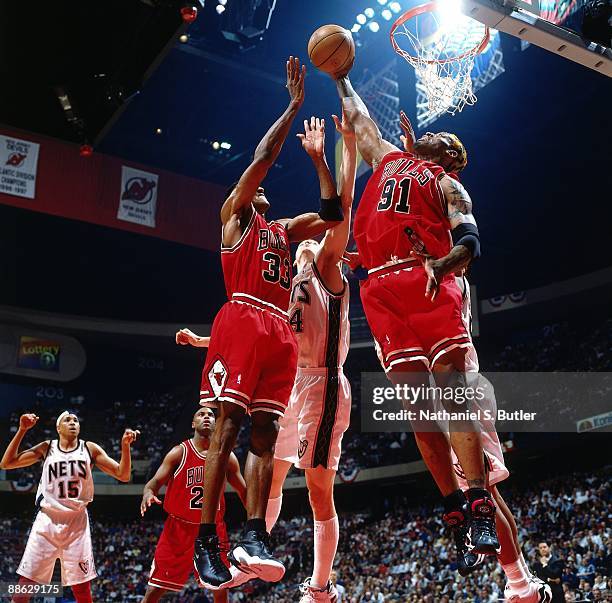 Dennis Rodman of the Chicago Bulls grabs a rebound against the New Jersey Nets in Game Three of Eastern Conference Quarterfinals during the 1998 NBA...