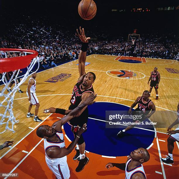 Alonzo Mourning of the Miami Heat shoots over Charles Oakley of the New York Knicks in Game Four of the Eastern Conference Semifinals during the 1997...