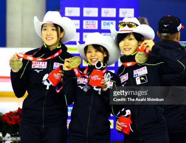 Gold medalists Ayaka Kikuchi, Nana Takagi and Miho Takagi of Japan celebrate on the podium at the medal ceremony for the women's team pursuit during...