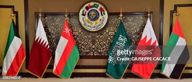 The flags of the countries attending the Gulf Cooperation Council summit are displayed at Bayan palace in Kuwait City on December 5, 2017. The Gulf...