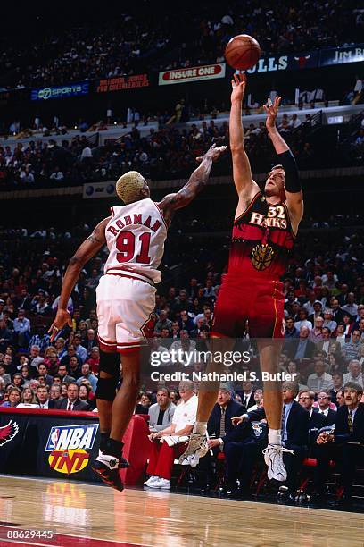 Christian Laettner of the Atlanta Hawks shoots a jump shot against Dennis Rodman of the Chicago Bulls in Game Two of the Eastern Conference...