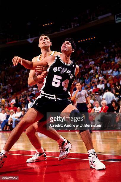 Jack Haley of the San Antonio Spurs boxes out Zan Tabak of the Houston Rockets in Game Four of the Western Conference Finals during the 1995 NBA...