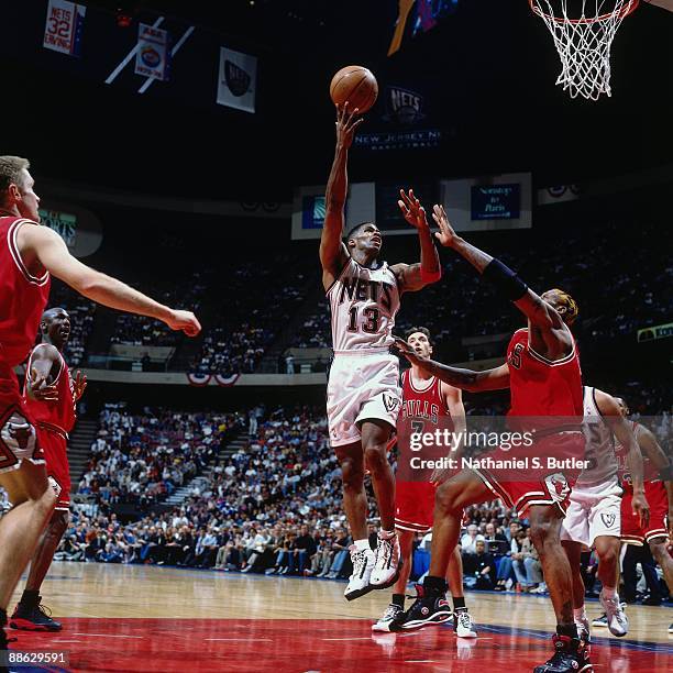 Kendall Gill of the New Jersey Nets shoots a layup against Dennis Rodman of the Chicago Bulls in Game Three of Eastern Conference Quarterfinals...