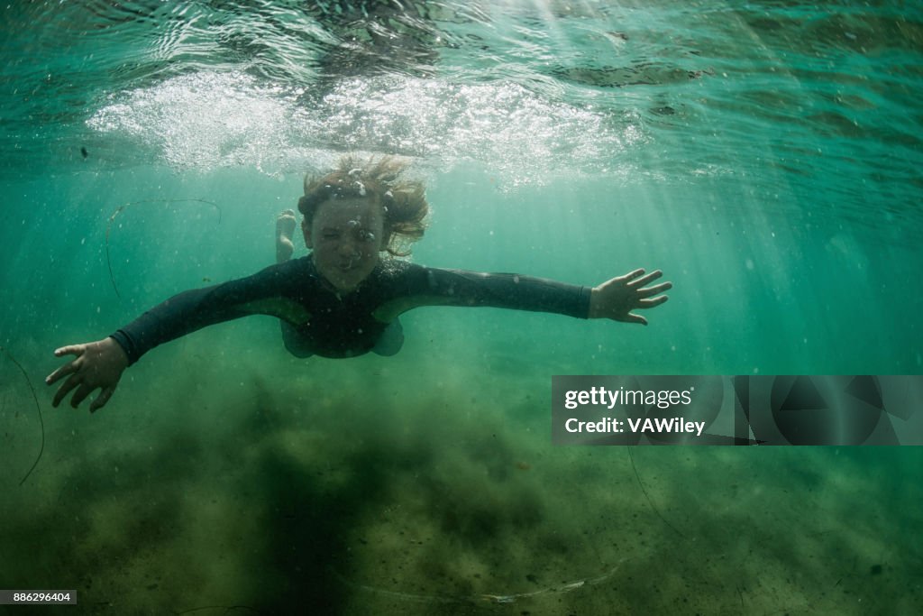 Boy exploring the ocean underwater