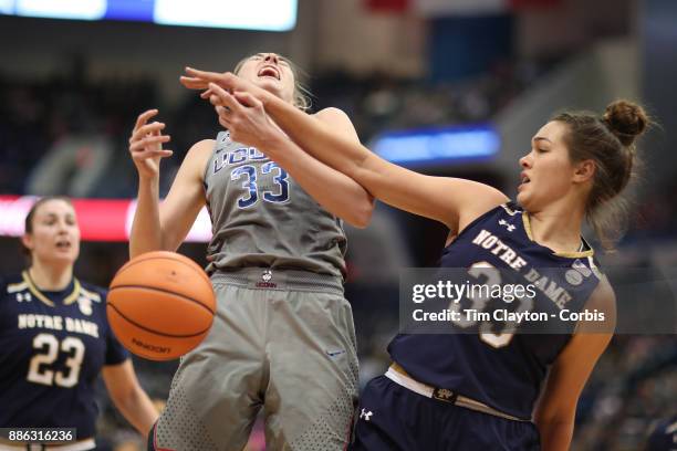 Katie Lou Samuelson of the Connecticut Huskies is challenged by Kathryn Westbeld of the Notre Dame Fighting Irish during the the UConn Huskies Vs...