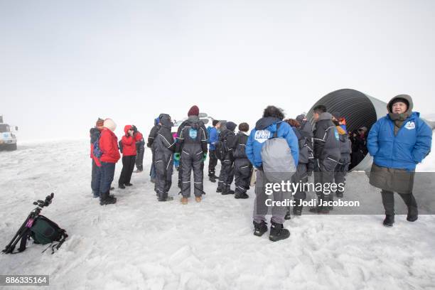 tourists getting ready to enter the ice caves inside the langjokull glacier, iceland - langjokull stock pictures, royalty-free photos & images